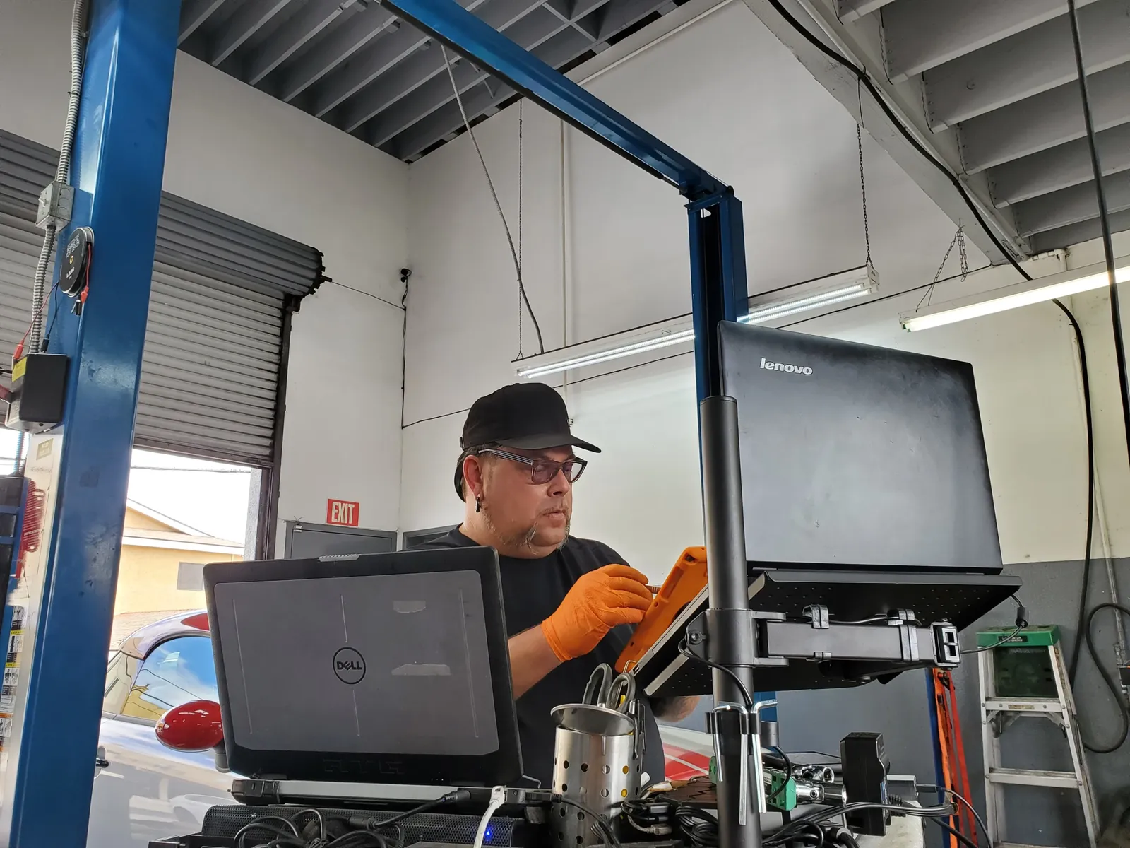 Import MotorWorx technician running factory diagnostics on a vehicle in the Lawndale shop
