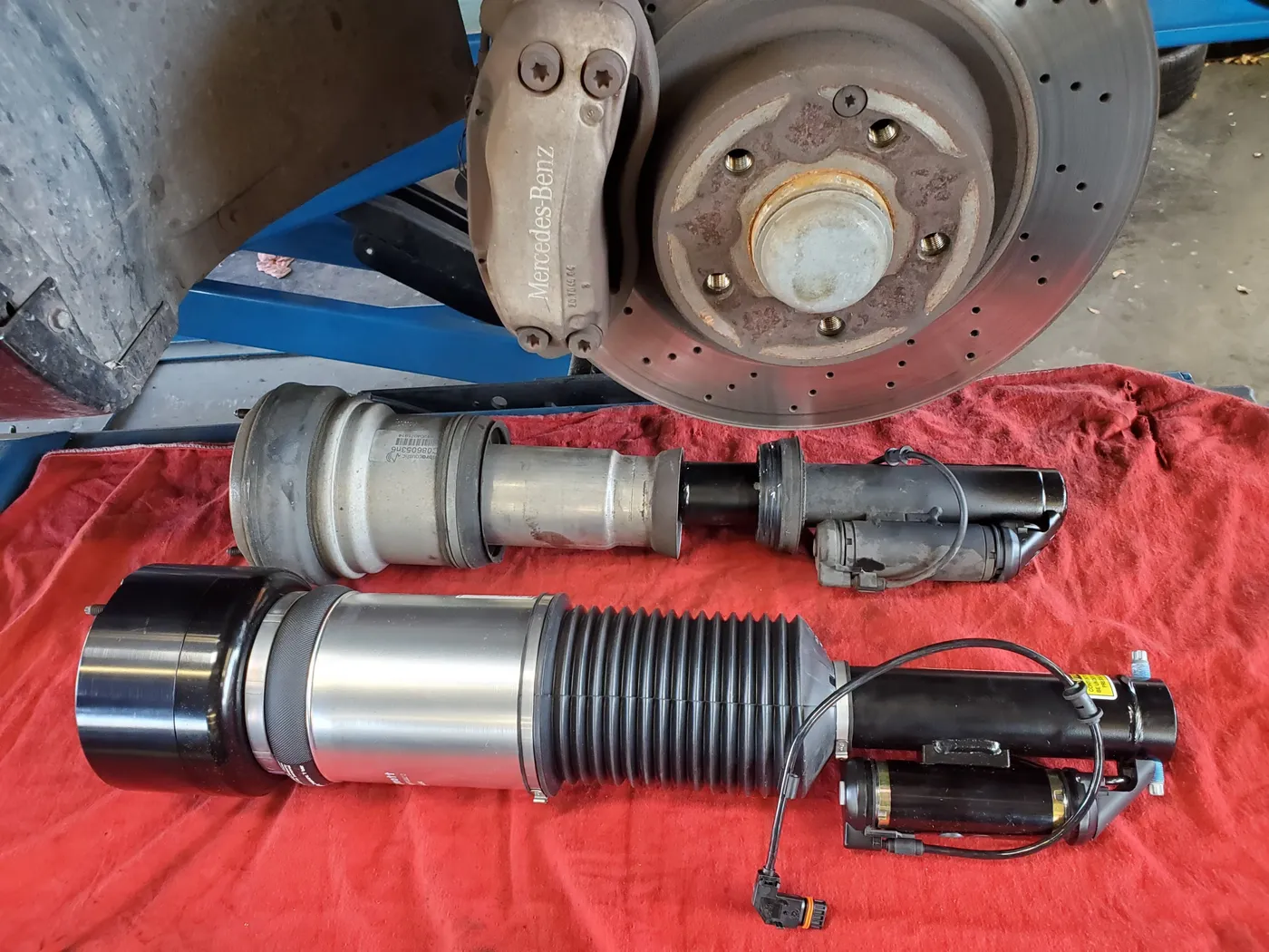 New suspension and brake components laid out before installation